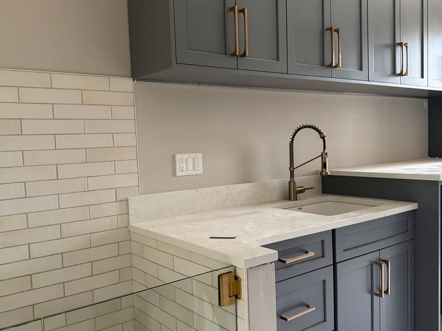 Painted blue gray shaker laundry cabinets with dog wash by Blue Mountain Design Bend Oregon